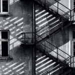 Family Escapes - Grayscale Photo of Building