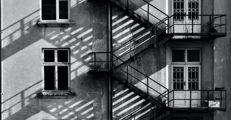 Family Escapes - Grayscale Photo of Building