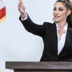 Event Hosting - Woman In Black Blazer Holding Us A Flag