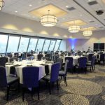 Dining Settings - A large room with blue lighting and tables