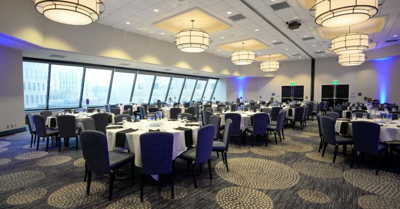 Dining Settings - A large room with blue lighting and tables