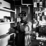 Local Experiences - Black man in VR goggles in electronics store