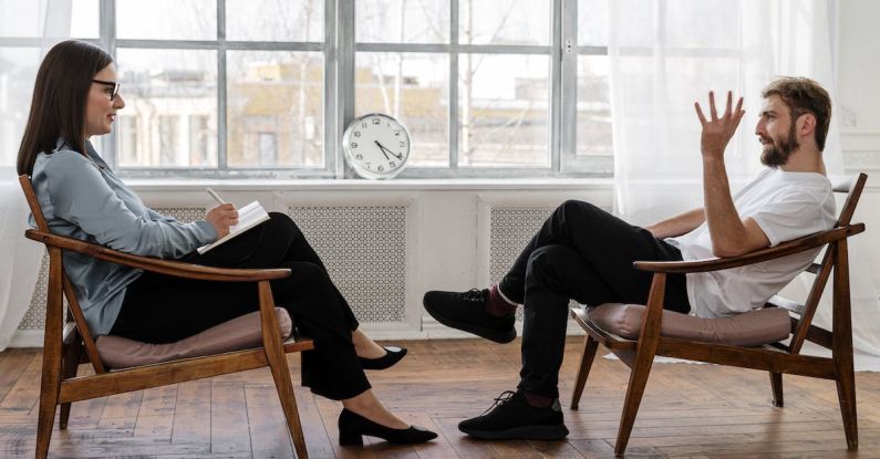 Nutritional Counseling - Person in Black Pants and Black Shoes Sitting on Brown Wooden Chair