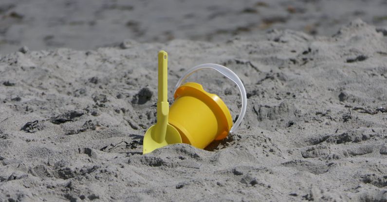 Seclusion - Yellow Plastic Bucket on Sand