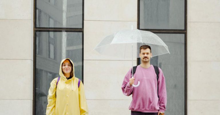 Owners - Dogs in Between the Man and Woman Standing