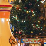 Large-Scale Event - Merry go round with large colorful traditional Russian teapot and cups in city park decorated in New Year style in evening