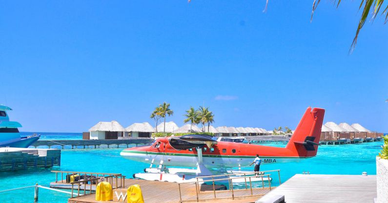 Exotic Villas - White and Red Seaplane on Body of Water