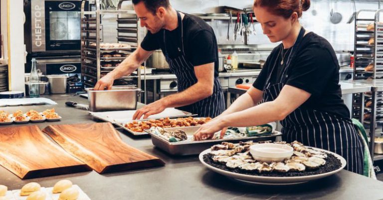 Chef Services - Man and Woman Wearing Black and White Striped Aprons Cooking