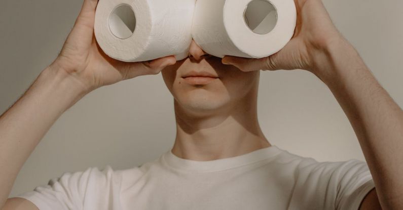 Safe Stay - Man in White Crew Neck Shirt Holding 2 White Tissue Rolls