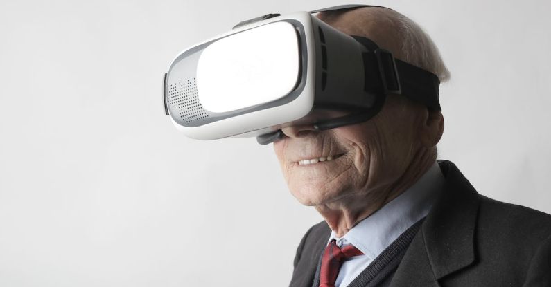 Immerse - Smiling elderly gentleman wearing classy suit experiencing virtual reality while using modern headset on white background