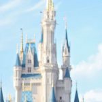 Romantic Excursions - White fairy tale castle with blue roofs in amusement park in Orlando against bright sky on sunny day
